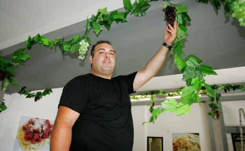 Rockhampton’s newest restaurant owner Joseph Rizkallah decorates the inside of his new business, Di Carlos, on the corner of Bolsover and Fitzroy streets, ahead of today’s opening. Rockhampton’s newest restaurant owner Joseph Rizkallah decorates the inside of his new business, Di Carlos, on the corner of Bolsover and Fitzroy streets, ahead of today’s opening.