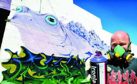 Ash Johnston working on a giant mural down the alley on Park Ave next to The Happy Frog. Ash Johnston working on a giant mural down the alley on Park Ave next to The Happy Frog.