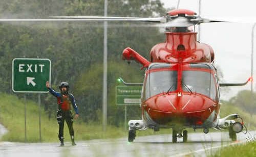 An EMQ AW139 helicopter lands on the Warrego Highway during the January floods, awaiting access to Amberley for refuelling before returning to Grantham for rescue services. An EMQ AW139 helicopter lands on the Warrego Highway during the January floods, awaiting access to Amberley for refuelling before returning to Grantham for rescue services.