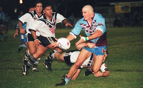 A Central Capras player offloads during a game from yesteryear. A Central Capras player offloads during a game from yesteryear.
