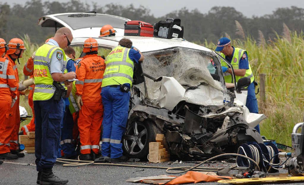 Rescue services try frantically to save the lives of two people trapped inside this vehicle involved in a double fatality on the Pacific Hwy at Chatsworth Island yesterday. Rescue services try frantically to save the lives of two people trapped inside this vehicle involved in a double fatality on the Pacific Hwy at Chatsworth Island yesterday.