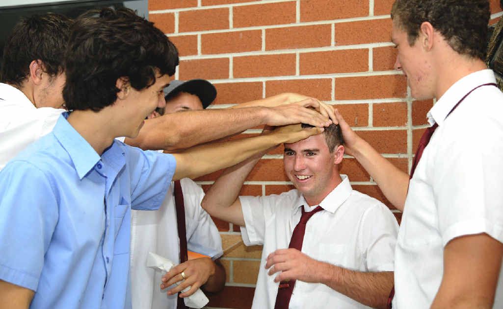 HEADS UP: Sam Hall is mobbed by his mates wanting a chance to feel his newly shaved head after he lost his locks for Shave for a Cure. The McAuley Catholic College Year 12 student had a very personal reason for doing the shave, after loosing his father Mark Hall to cancer. Photo: JoJo Newby HEADS UP: Sam Hall is mobbed by his mates wanting a chance to feel his newly shaved head after he lost his locks for Shave for a Cure. The McAuley Catholic College Year 12 student had a very personal reason for doing the shave, after loosing his father Mark Hall to cancer. Photo: JoJo Newby