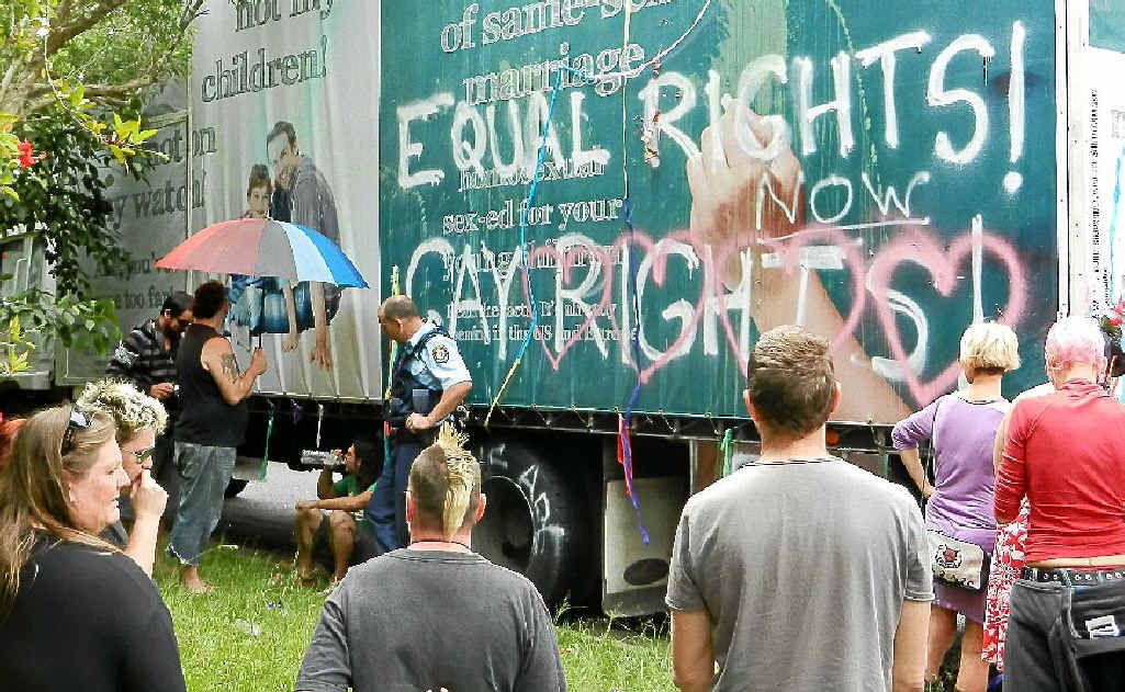 Protesters at the mobile billboard in Lismore on Sunday. Two people chained themselves to the truck and were released by Police Rescue. Protesters at the mobile billboard in Lismore on Sunday. Two people chained themselves to the truck and were released by Police Rescue.