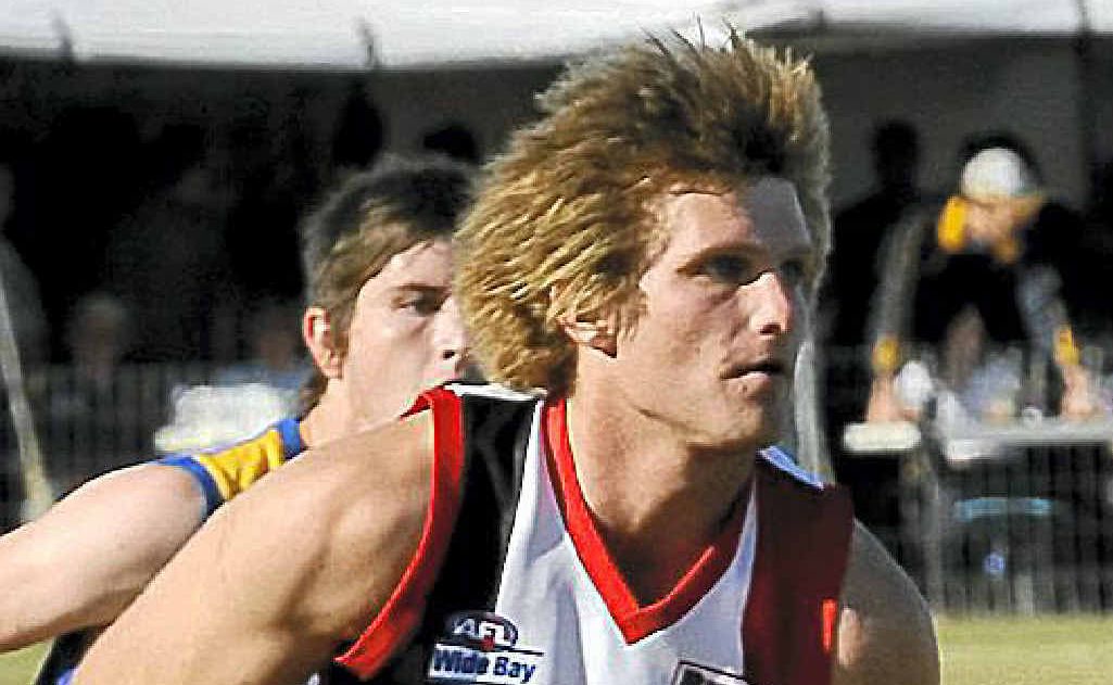Brothers Bulldogs’ Craig Bek handballs to safety against Across The Waves at Frank Coulthard Oval last season. Brothers Bulldogs’ Craig Bek handballs to safety against Across The Waves at Frank Coulthard Oval last season.