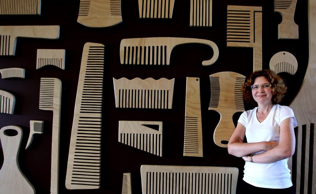 Sherrie Knipe in front of some of her oversized combs. Sherrie Knipe in front of some of her oversized combs.