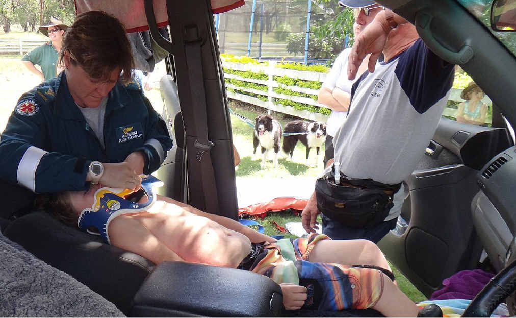 Paramedics attend to an eight-year-old boy who was sucked into a storm water drain west of Mackay. Paramedics attend to an eight-year-old boy who was sucked into a storm water drain west of Mackay.