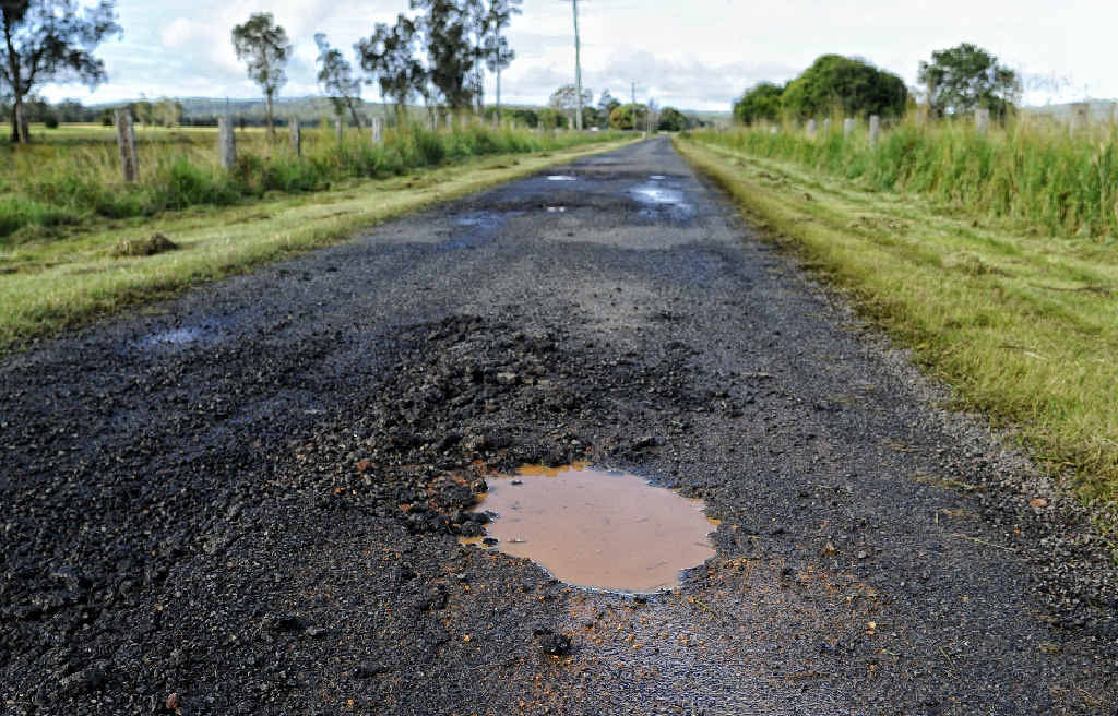 Pot holes in the road on Calligans Creek Road, Calliope. Pot holes in the road on Calligans Creek Road, Calliope.