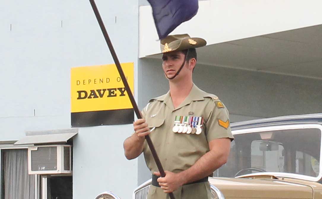 HONOURED: Former Proserpine resident Bombardier Herbert Larsen-Bayer took part in his first ANZAC Day ceremony in his home town and lead the Proserpine procession holding the Australian flag HONOURED: Former Proserpine resident Bombardier Herbert Larsen-Bayer took part in his first ANZAC Day ceremony in his home town and lead the Proserpine procession holding the Australian flag