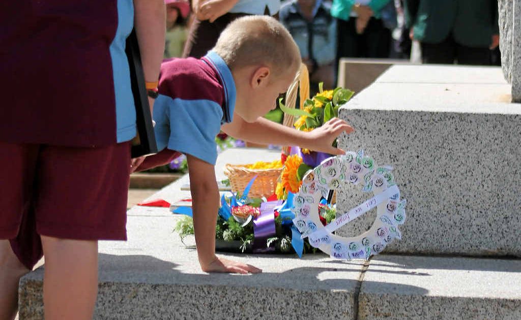 Zach Colless lays his hand-made paper wreath at the cenotaph. Zach Colless lays his hand-made paper wreath at the cenotaph.