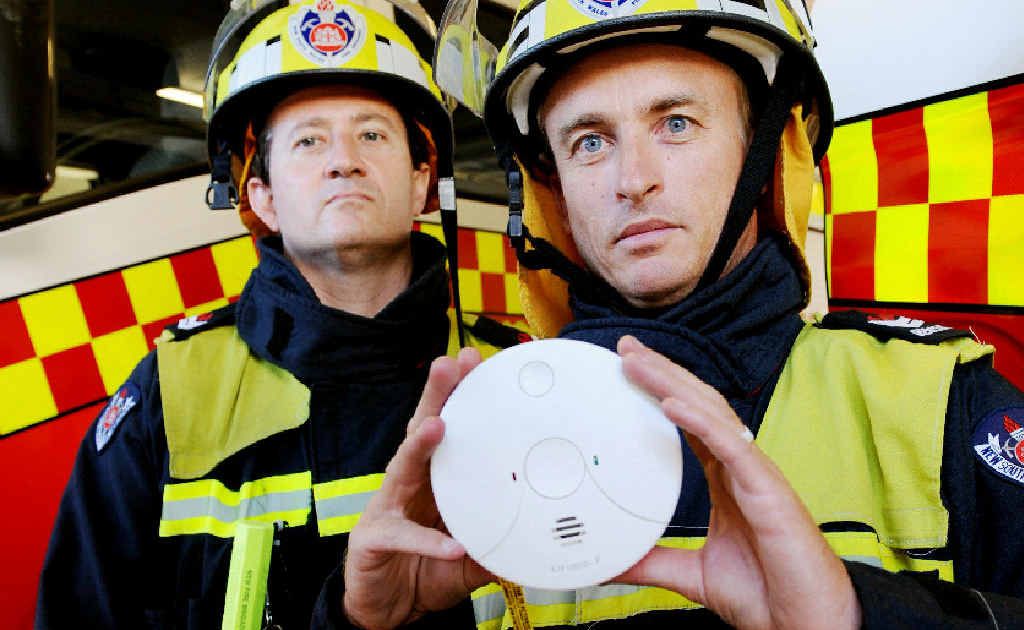 Lismore Fire Brigade senior firefighter Mike Grunske and firefighter Justin Hyde with a photo-electric smoke alarm. Lismore Fire Brigade senior firefighter Mike Grunske and firefighter Justin Hyde with a photo-electric smoke alarm.