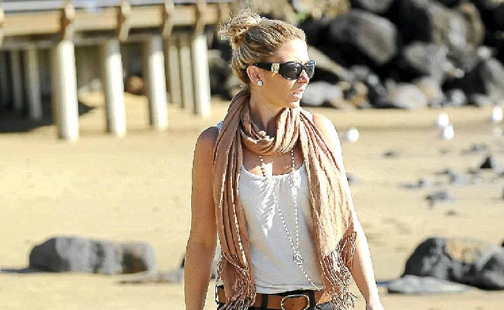 Kirstie Oldham strolls along the beach at Bargara yesterday despite some chilly temperatures. Kirstie Oldham strolls along the beach at Bargara yesterday despite some chilly temperatures.