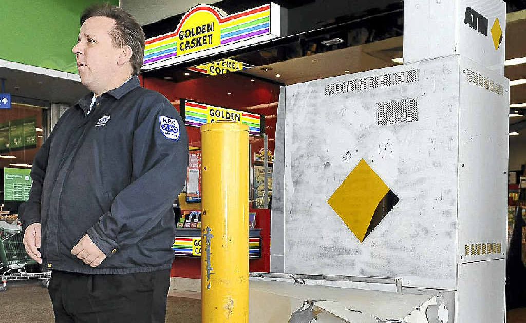 RPO Security officer Justin Tainton stands watch near an ATM that was targeted by thieves in the Bargara Central complex. RPO Security officer Justin Tainton stands watch near an ATM that was targeted by thieves in the Bargara Central complex.