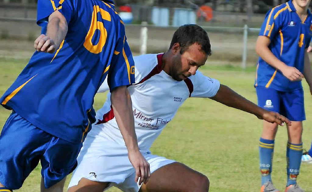 Warwick Wolves player Johnny Enosa (white shirt) tries to beat a USQ opponent. Warwick Wolves player Johnny Enosa (white shirt) tries to beat a USQ opponent.