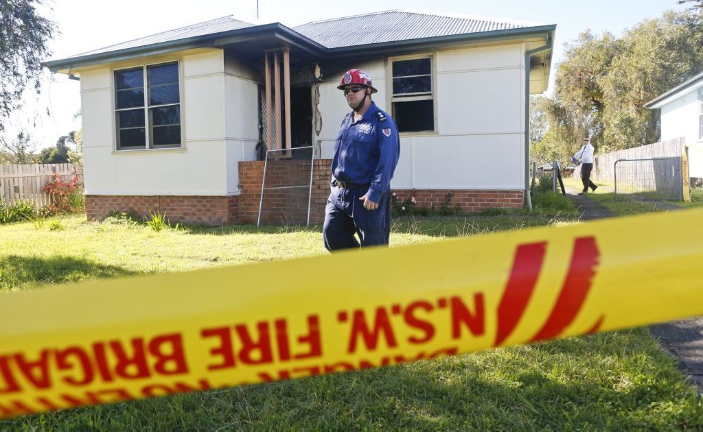 Fire Rescue NSW Grafton Station office Michael Kearns walks out the front of a property where a woman was killed in a house fire. Fire Rescue NSW Grafton Station office Michael Kearns walks out the front of a property where a woman was killed in a house fire.