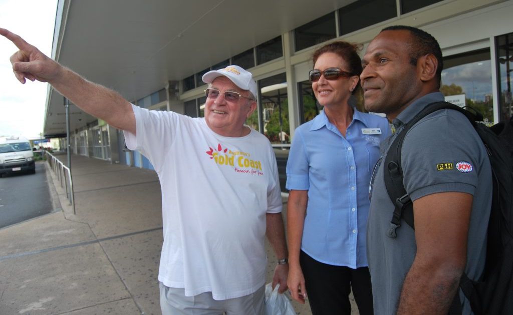 Gold Coast Tourism volunteer Des Guarde and Coolangatta Information Centre assistant manager Gayle Tucker give visitor Eddie Megao directions at Gold Coast Airport. Gold Coast Tourism volunteer Des Guarde and Coolangatta Information Centre assistant manager Gayle Tucker give visitor Eddie Megao directions at Gold Coast Airport.
