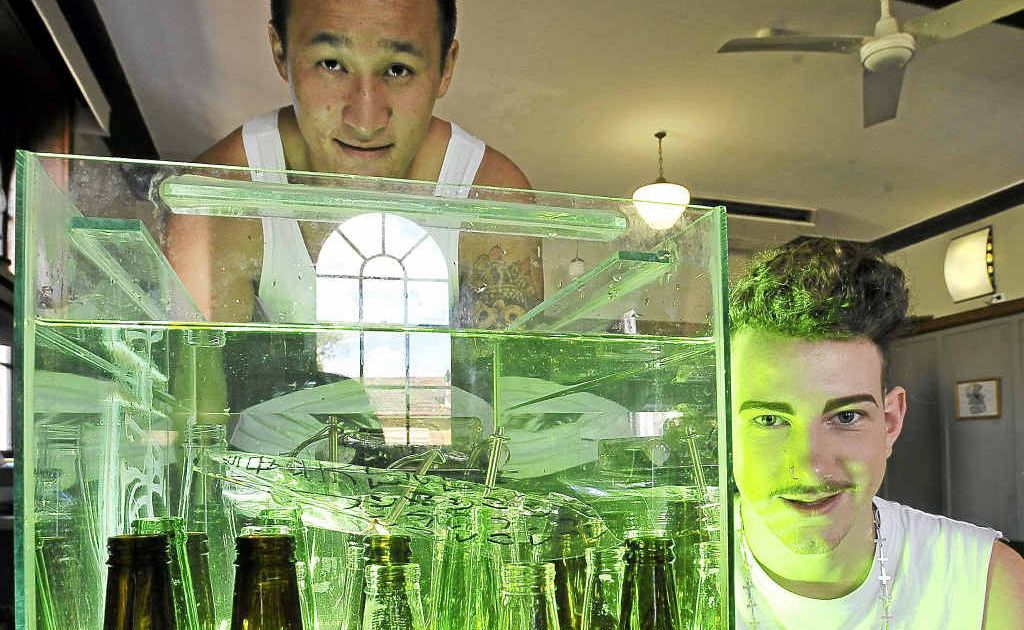 Southern Cross University students Paul Tran, left, and Ben Avery with Ben’s artwork, Toxic. Southern Cross University students Paul Tran, left, and Ben Avery with Ben’s artwork, Toxic.