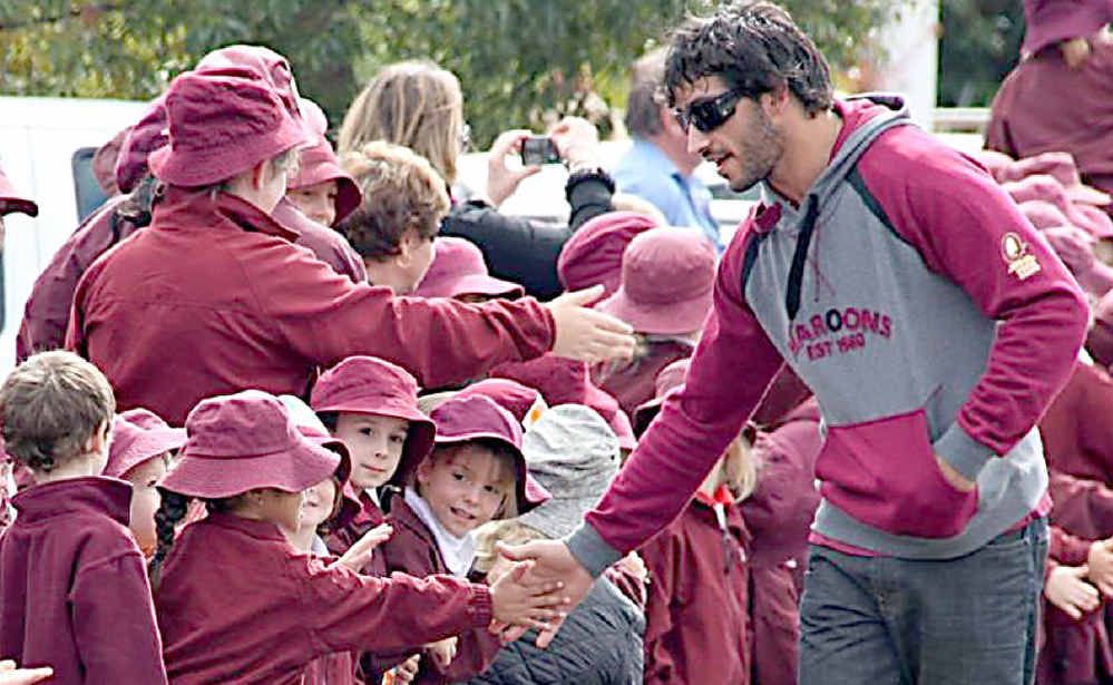 Maroons five-eighth Johnathan Thurston meets Roma school children during the street parade. Maroons five-eighth Johnathan Thurston meets Roma school children during the street parade.