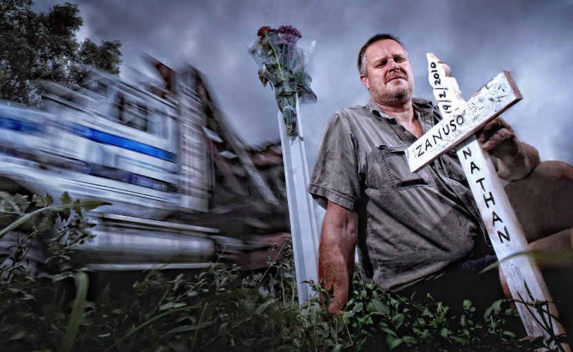 Paul Zanuso, father of Nathan Zanuso who was killed on the Pacific Highway in 2010, plants a cross at the scene. Paul Zanuso, father of Nathan Zanuso who was killed on the Pacific Highway in 2010, plants a cross at the scene.