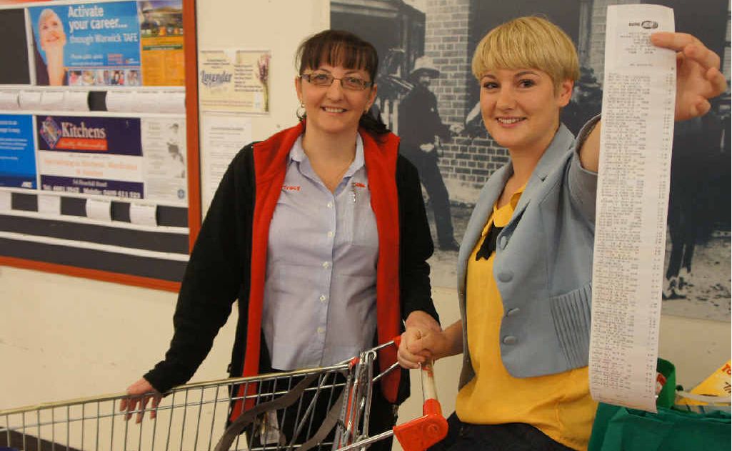 Nicki Stacey (right) zoomed through the aisles, racking up $647.45 worth of groceries in three minutes. Warwick Supa IGA co-owner Tracy Smith swiped her items through the register. Nicki Stacey (right) zoomed through the aisles, racking up $647.45 worth of groceries in three minutes. Warwick Supa IGA co-owner Tracy Smith swiped her items through the register.