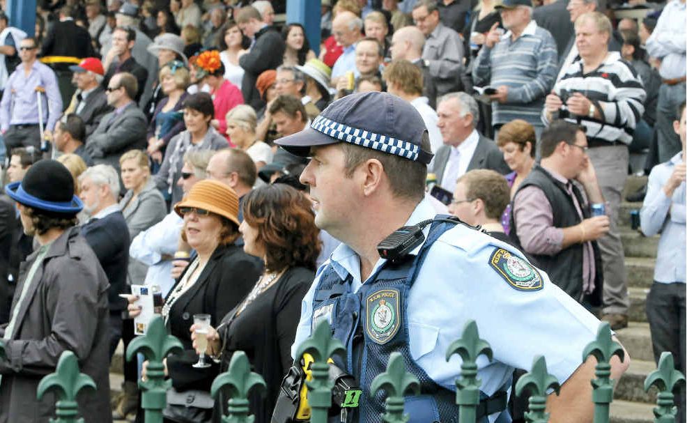 Constable David Ford takes a look over the large crowd on Grafton Cup day. Constable David Ford takes a look over the large crowd on Grafton Cup day.