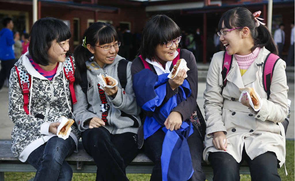 SNAG TIME: Beijing school students Stephanie Ji, Will Liang, Gabriel Zhang and Sterope Cheng enjoy a sausage sandwich on a visit to Clarence Valley Anglican School. Photo: Adam Hourigan SNAG TIME: Beijing school students Stephanie Ji, Will Liang, Gabriel Zhang and Sterope Cheng enjoy a sausage sandwich on a visit to Clarence Valley Anglican School. Photo: Adam Hourigan