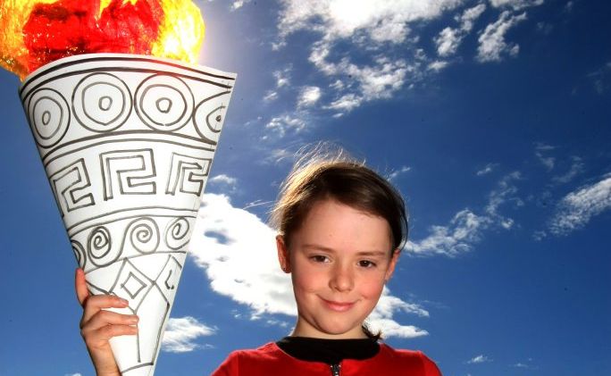 Sidera Dyer, age 8, holds the torch aloft. Sidera Dyer, age 8, holds the torch aloft.