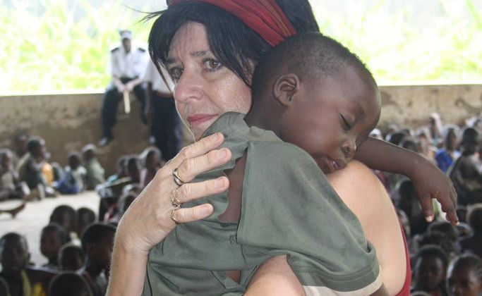 Bundaberg's Cathy Booth comforts a child at the Umoja Orphanage in Kenya. Bundaberg's Cathy Booth comforts a child at the Umoja Orphanage in Kenya.