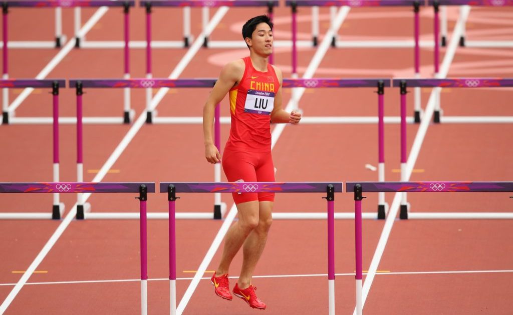 Xiang Liu of China hops on the track after getting injured in the Men's 110m Hurdles Round 1 Heats on Day 11 of the London 2012 Olympic Games at Olympic Stadium on August 7, 2012 in London, England. Xiang Liu of China hops on the track after getting injured in the Men's 110m Hurdles Round 1 Heats on Day 11 of the London 2012 Olympic Games at Olympic Stadium on August 7, 2012 in London, England.