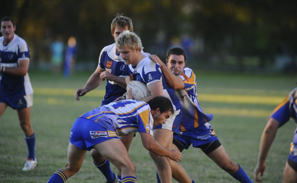 Ghosts' Sam Hartmann is grabbed by some Mustangs during round 9 NRRRL rugby league clash at McGuren Field, Grafton. Ghosts' Sam Hartmann is grabbed by some Mustangs during round 9 NRRRL rugby league clash at McGuren Field, Grafton.