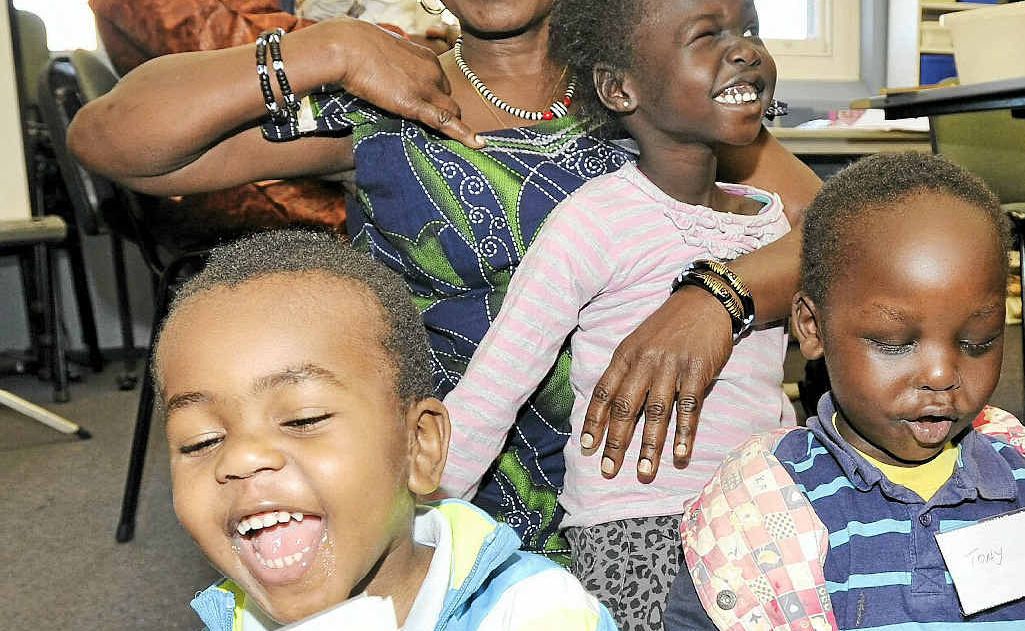 Learning English through the written word at Lismore library were (left at back) Djidji Mapatano and baby Julian (4 months), (front, from left) Daniel Mapatano, 3, Helen Deng, Adut Makvac, 4, and Tony Hezron, 3. Learning English through the written word at Lismore library were (left at back) Djidji Mapatano and baby Julian (4 months), (front, from left) Daniel Mapatano, 3, Helen Deng, Adut Makvac, 4, and Tony Hezron, 3.