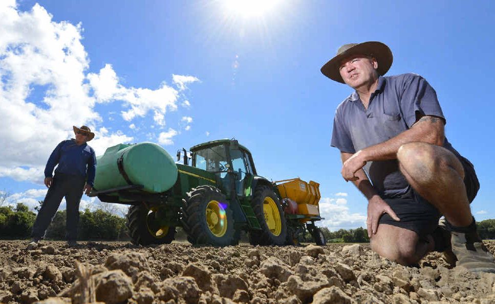 Ross Farlow (front) and Bruce Ellem planting cane on Alan Cameron’s farm. They would now like some follow-up rain. Ross Farlow (front) and Bruce Ellem planting cane on Alan Cameron’s farm. They would now like some follow-up rain.