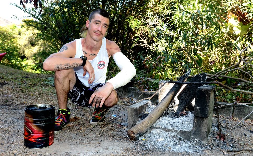 Jesse Lewis with the fuel can and barbecue at his home where he suffered burns. Jesse Lewis with the fuel can and barbecue at his home where he suffered burns.
