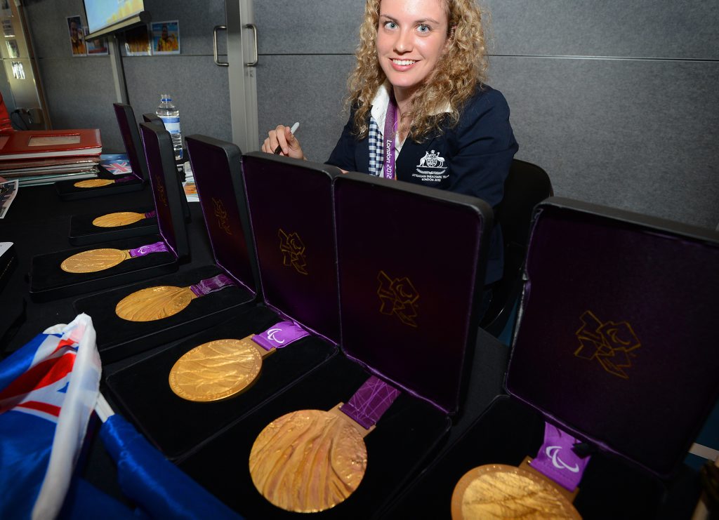 Paralympian Swimmer Jacqueline Freney pictured with her medals, signing autographs last year. Paralympian Swimmer Jacqueline Freney pictured with her medals, signing autographs last year.