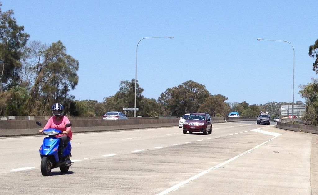 What the? A scooter rider is seen heading south along the Pacific Hwy just after Terranora Creek Bridge. What the? A scooter rider is seen heading south along the Pacific Hwy just after Terranora Creek Bridge.