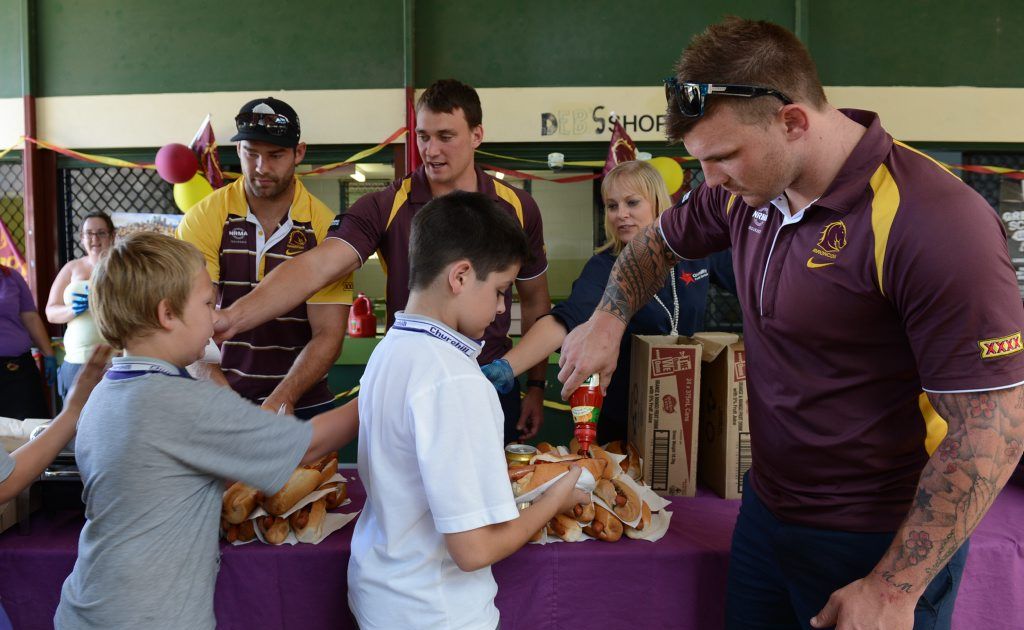 Churchill State School students Kale Harris and Josh Etherden having her lunch served up by Broncos players, Scott Anderson, Nick Slyney and Josh McGuire, after the school tuckshop won a competition run by Hans. Churchill State School students Kale Harris and Josh Etherden having her lunch served up by Broncos players, Scott Anderson, Nick Slyney and Josh McGuire, after the school tuckshop won a competition run by Hans.