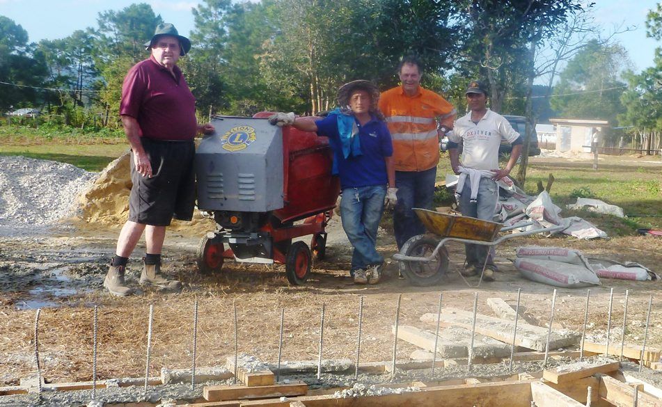 Terranora Lion Peter Maroney, fellow MiVAC volunteer Michael Weibler and locals Vang and Mua with the mixer. Photo: Contributed Terranora Lion Peter Maroney, fellow MiVAC volunteer Michael Weibler and locals Vang and Mua with the mixer. Photo: Contributed