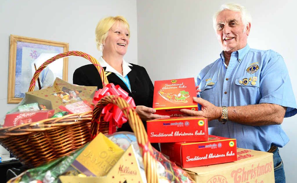 FESTIVE TREAT: Lowood Lions Club president Kevin Larsen hands over fundraising Christmas cakes to Stitt and St George Funeral Directors branch manager Alison Crabtree. FESTIVE TREAT: Lowood Lions Club president Kevin Larsen hands over fundraising Christmas cakes to Stitt and St George Funeral Directors branch manager Alison Crabtree.