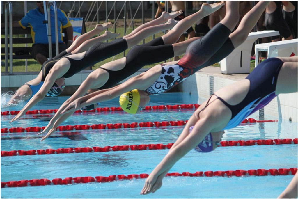Kala Rideout (yellow cap) dives off the block during last weekend's carnival. Karla took out the 13 girls Age Champion title at the meet. Photo Contributed Kala Rideout (yellow cap) dives off the block during last weekend's carnival. Karla took out the 13 girls Age Champion title at the meet. Photo Contributed