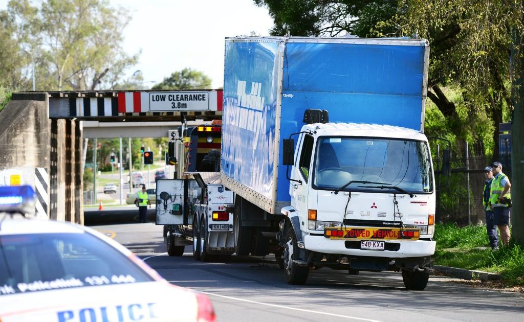 A tow truck prepares to remove a hire truck that struck the railway bridge on Layard Street in Goodna. A tow truck prepares to remove a hire truck that struck the railway bridge on Layard Street in Goodna.