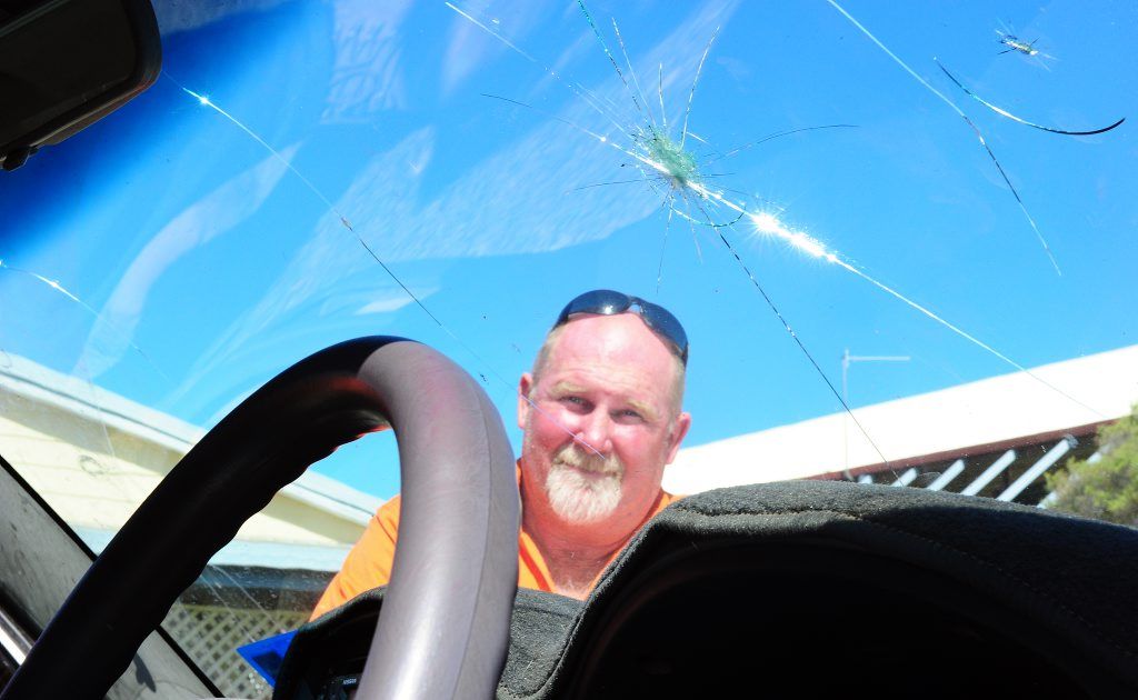 Dale Johnson is not happy with his damaged windscreen caused by a flying rock on Port Curtis Way. Dale Johnson is not happy with his damaged windscreen caused by a flying rock on Port Curtis Way.