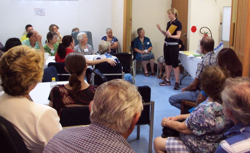 LEARNING: The group listens intently to how to prevent falls at home. LEARNING: The group listens intently to how to prevent falls at home.