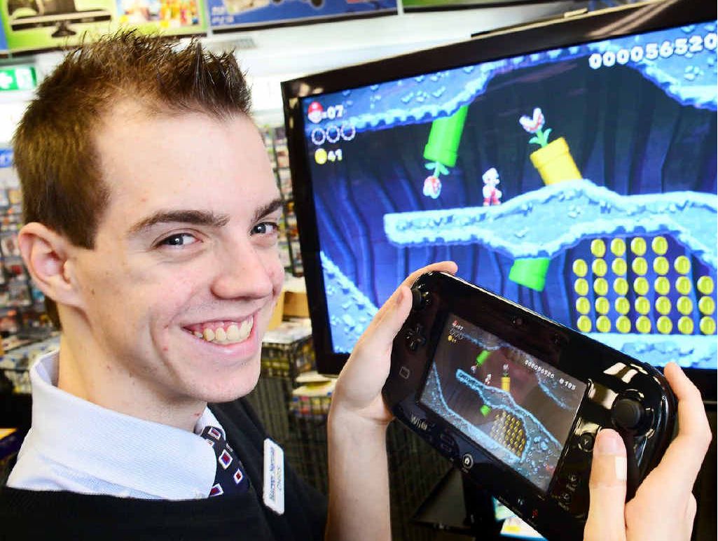 BIG STEP UP: Harvey Norman Ipswich salesman Chris Malone test drives the Wii U. BIG STEP UP: Harvey Norman Ipswich salesman Chris Malone test drives the Wii U.