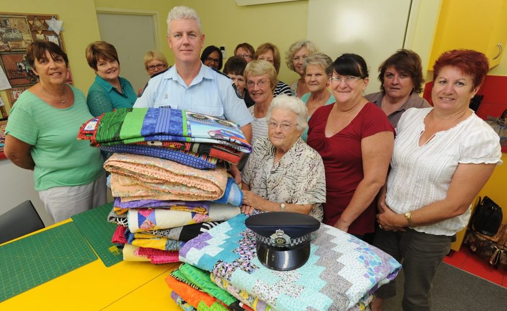 Senior Sergeant Dan Willett accepts 22 quilts for Police Legacy from Hervey Bay Social Quilters including the group's oldest member Joyce Murphy. Senior Sergeant Dan Willett accepts 22 quilts for Police Legacy from Hervey Bay Social Quilters including the group's oldest member Joyce Murphy.