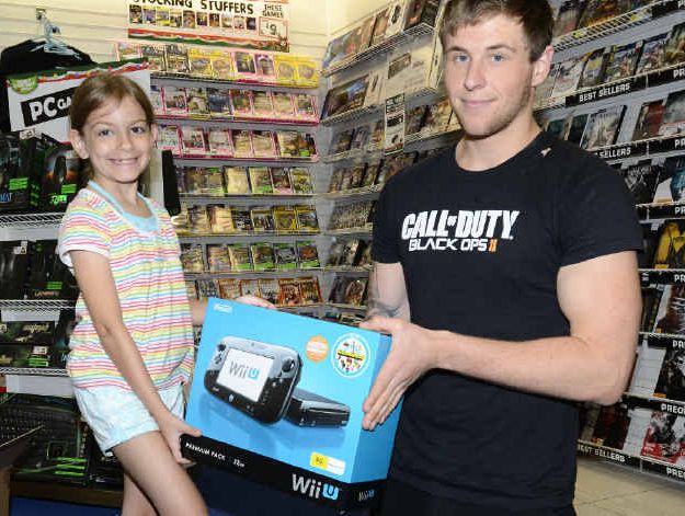 Grafton Shopping World EB Games manager Brian Ryan shows seven- year-old customer Angel Marre Hawkins Ford the new W11-U console. Photo Debrah Novak Grafton Shopping World EB Games manager Brian Ryan shows seven- year-old customer Angel Marre Hawkins Ford the new W11-U console. Photo Debrah Novak