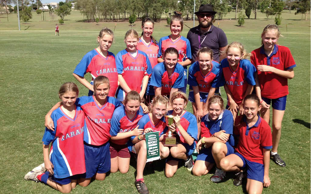 Winning teams Karalee (left) and St Mary’s enjoy their Aussie rules grand final victories. Winning teams Karalee (left) and St Mary’s enjoy their Aussie rules grand final victories.