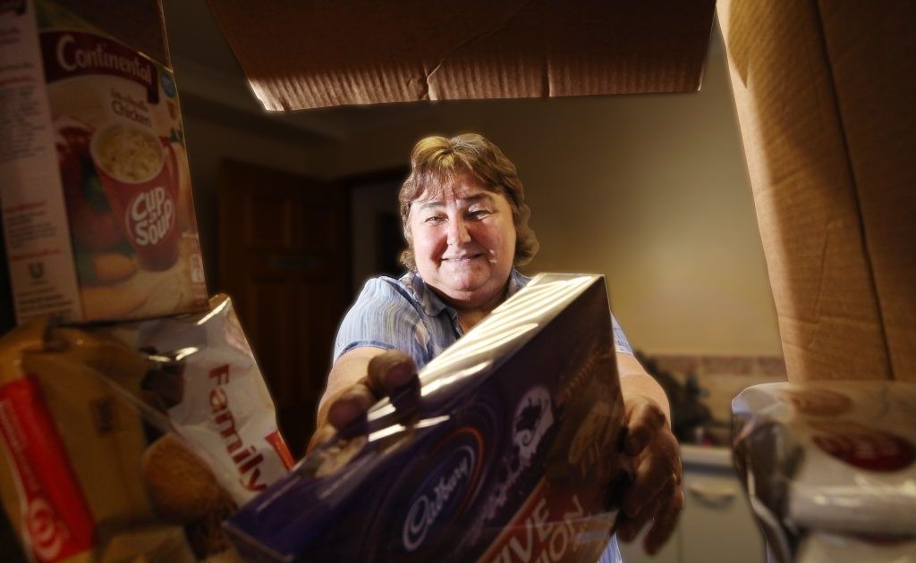 Colleen Benson from the Logan East Community Neighbourhood Association with hampers collected for the 2012 Adopt-A-Family. Photo: Inga Williams / The Reporter Colleen Benson from the Logan East Community Neighbourhood Association with hampers collected for the 2012 Adopt-A-Family. Photo: Inga Williams / The Reporter