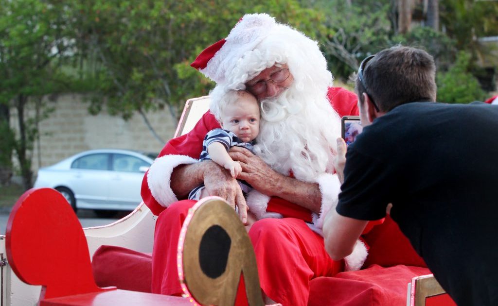 Michael Cramer taking 13-week-old Levi to visit Santa in his sleigh at Jindalee. Photo: Inga Williams / The Satellite Michael Cramer taking 13-week-old Levi to visit Santa in his sleigh at Jindalee. Photo: Inga Williams / The Satellite