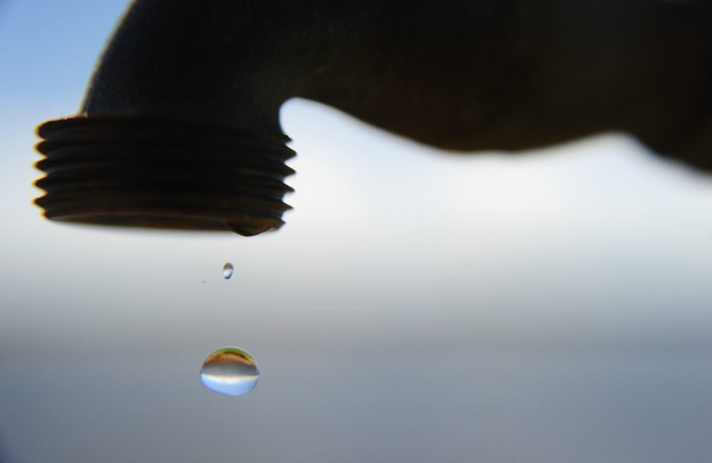 Water dripping from tap. Water dripping from tap.