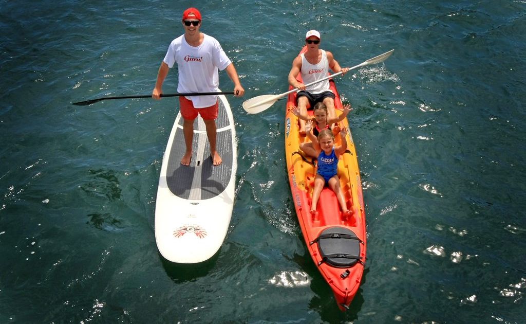 Mick Munday takes Kaitlin 7 and Zoe 4 McMahon for a kyak while Paddleboard expert Dean Kenny tags along. Photo: Blainey Woodham / Daily News Mick Munday takes Kaitlin 7 and Zoe 4 McMahon for a kyak while Paddleboard expert Dean Kenny tags along. Photo: Blainey Woodham / Daily News