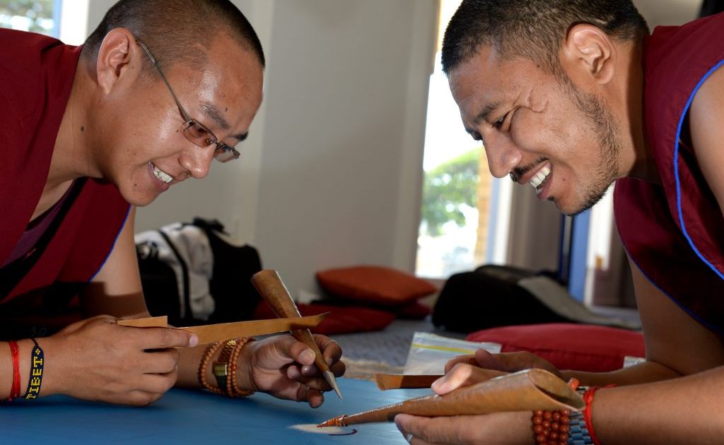 Phunysok Lhundup and Tenpa Gyamtso working on their sand art. Phunysok Lhundup and Tenpa Gyamtso working on their sand art.